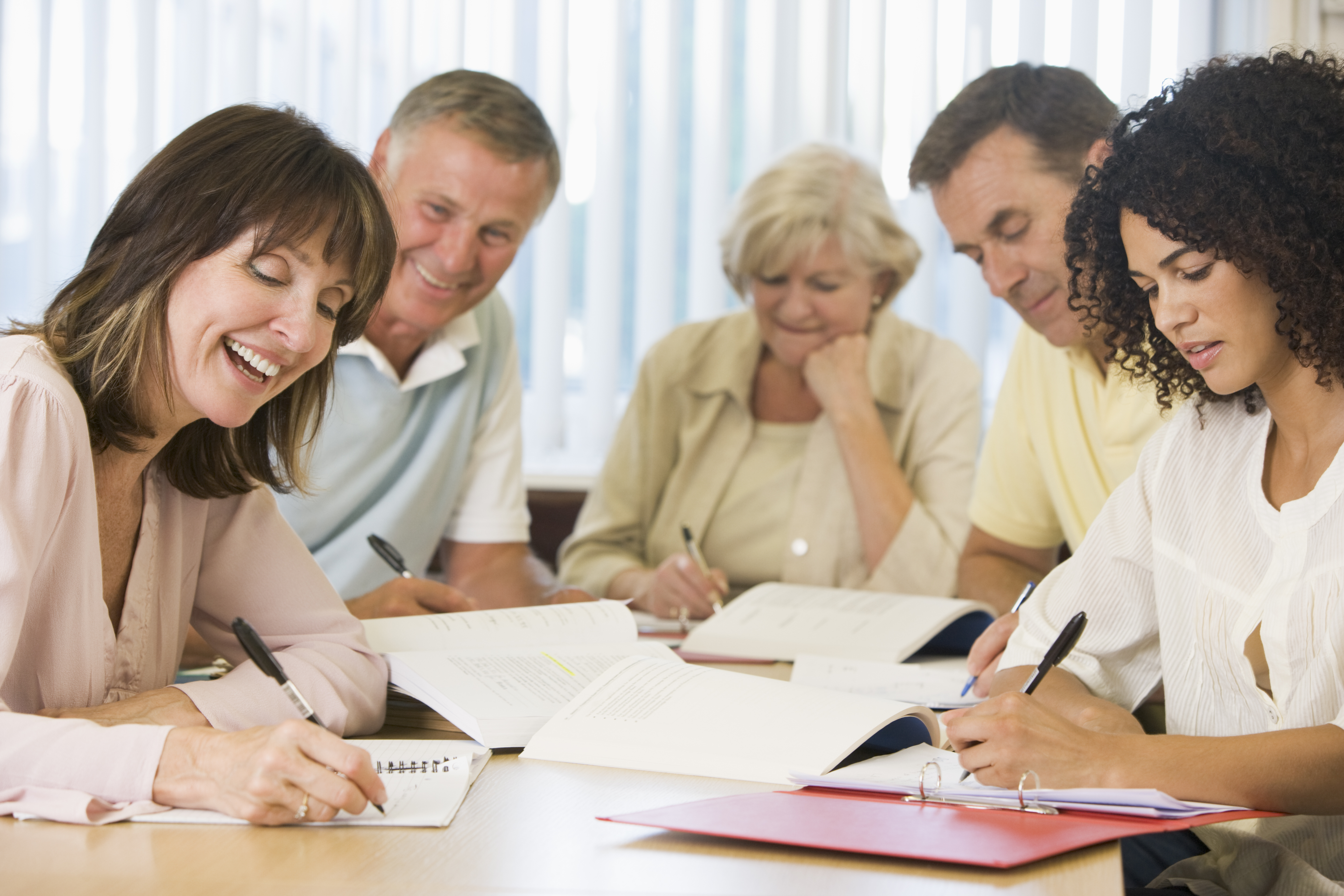 Five people gathered around a table