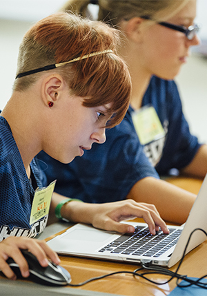 Two girls participating in Minecraft 101 with computer
