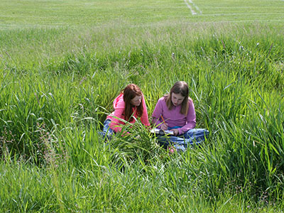 MT Girls STEM two girls in a grassy field
