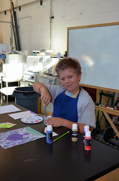Boy working with acrylic paint