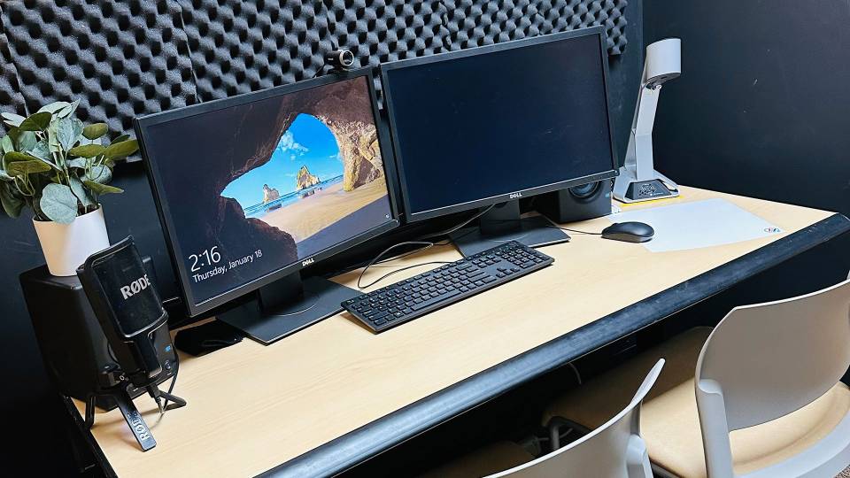 desk with computer and microphone