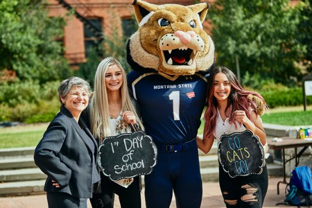 President Cruzado, two students, and Champ on the first day of classes