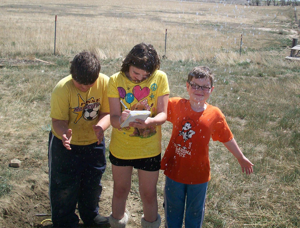 CLIMB three kids outside doing an activity