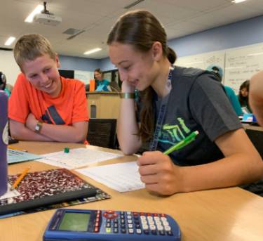 Girl and Boy Working on Math Work