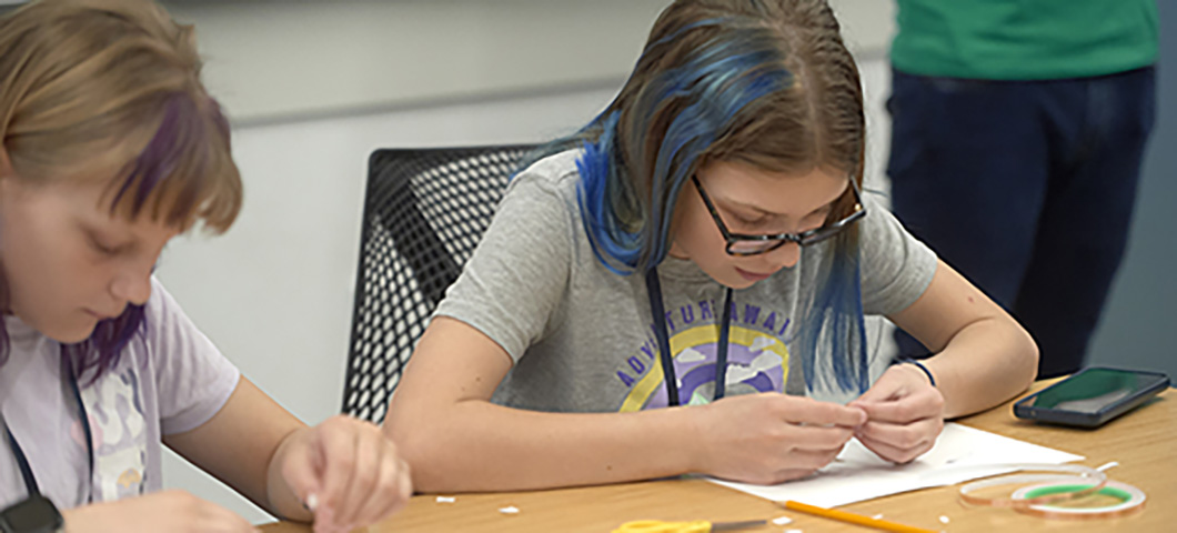 Two youth working on a project