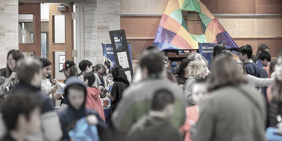 Crowd visiting displays at a science event