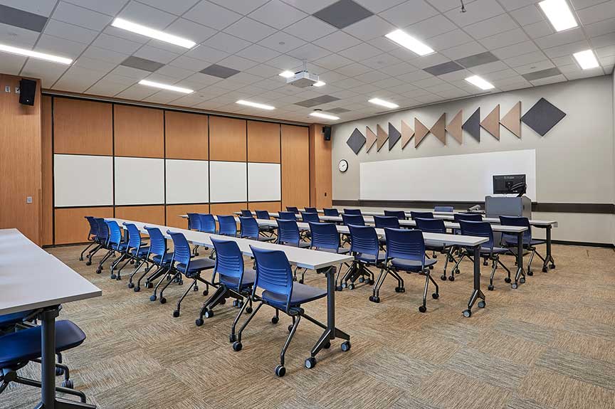 Classroom with long tables and a display on the wall in American Indian Hall