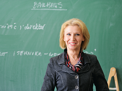 Female professor in front of a chalkboard